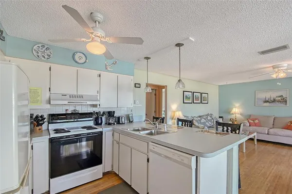a kitchen with a sink cabinets and stainless steel appliances