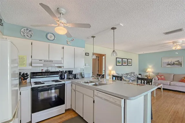 a kitchen with a sink cabinets and stainless steel appliances