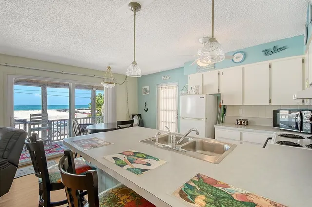 a view of kitchen with dining table and chairs