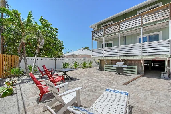 a backyard of a house with a table and chairs