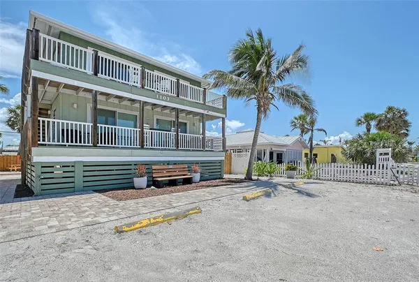 a backyard of a house with outdoor seating