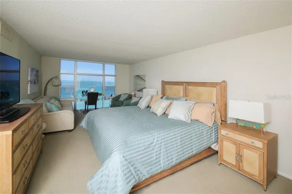 a bedroom with a large bed and a couch