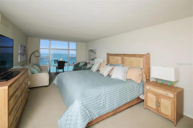 a bedroom with a large bed and a couch