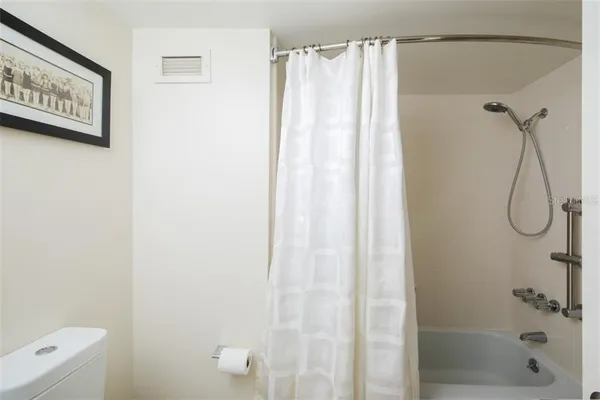 a bathroom with a shower and a shower curtain