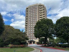 a front view of a residential apartment building with trees