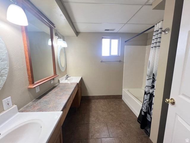 640 West Cyn Road Ferron, UT 84523 - Photo 28 of 45 Basement Bathroom featuring double vanity and shower / bath combination with curtain