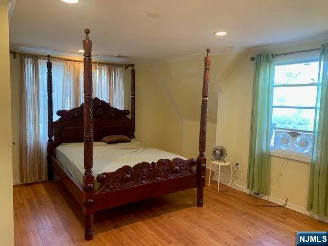 a bedroom with a bed window and a mirror