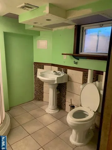 a bathroom with a toilet and a sink