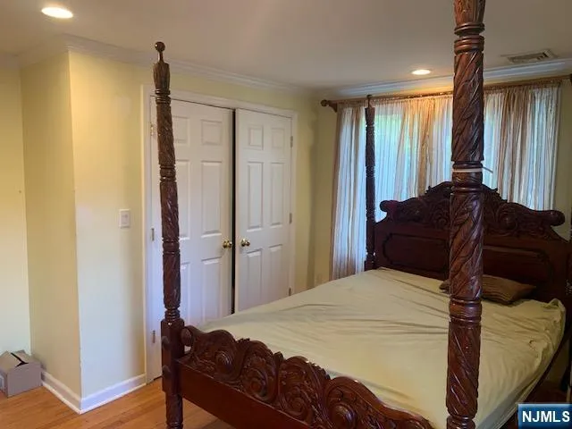 a bedroom with a bed and a mirror