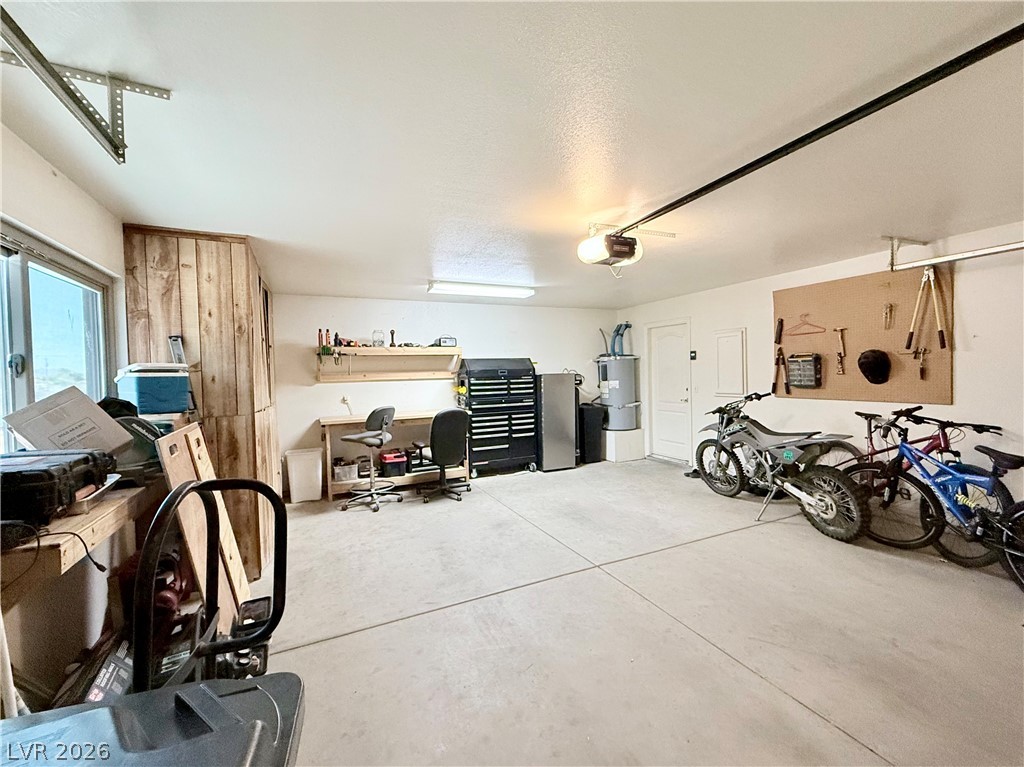 1220 East Gamebird Road Pahrump, NV 89048 - Photo 37 of 49 A spacious 2 car garage provides ample room for vehicles and a dedicated workbench area.