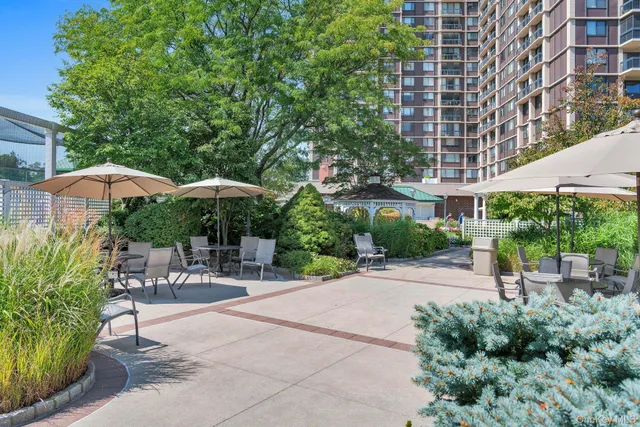 a view of a wooden house with a small yard and wooden fence