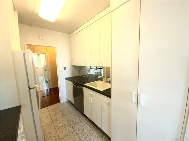a kitchen with a sink and refrigerator