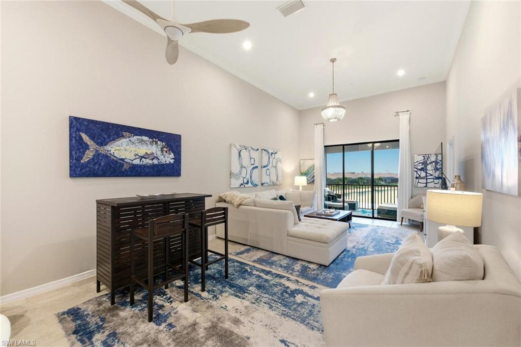 9365 Pocida Court, Unit 202 Naples, FL 34119 - Photo 10 of 40 a living room with furniture a dining table and a fireplace