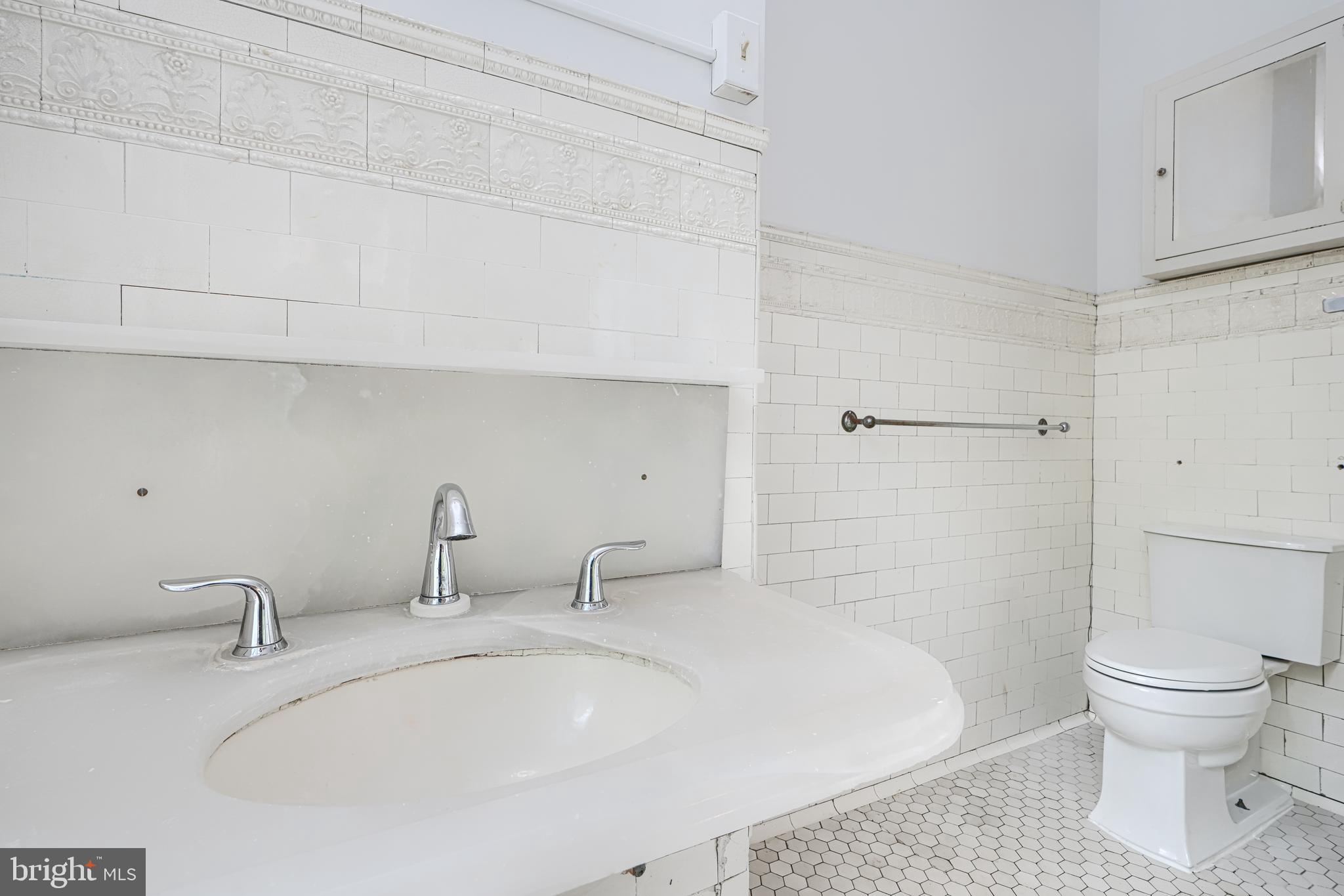 210 Ridgewood Road Baltimore, MD 21210 - Photo 31 of 84 a bathroom with a sink and a toilet
