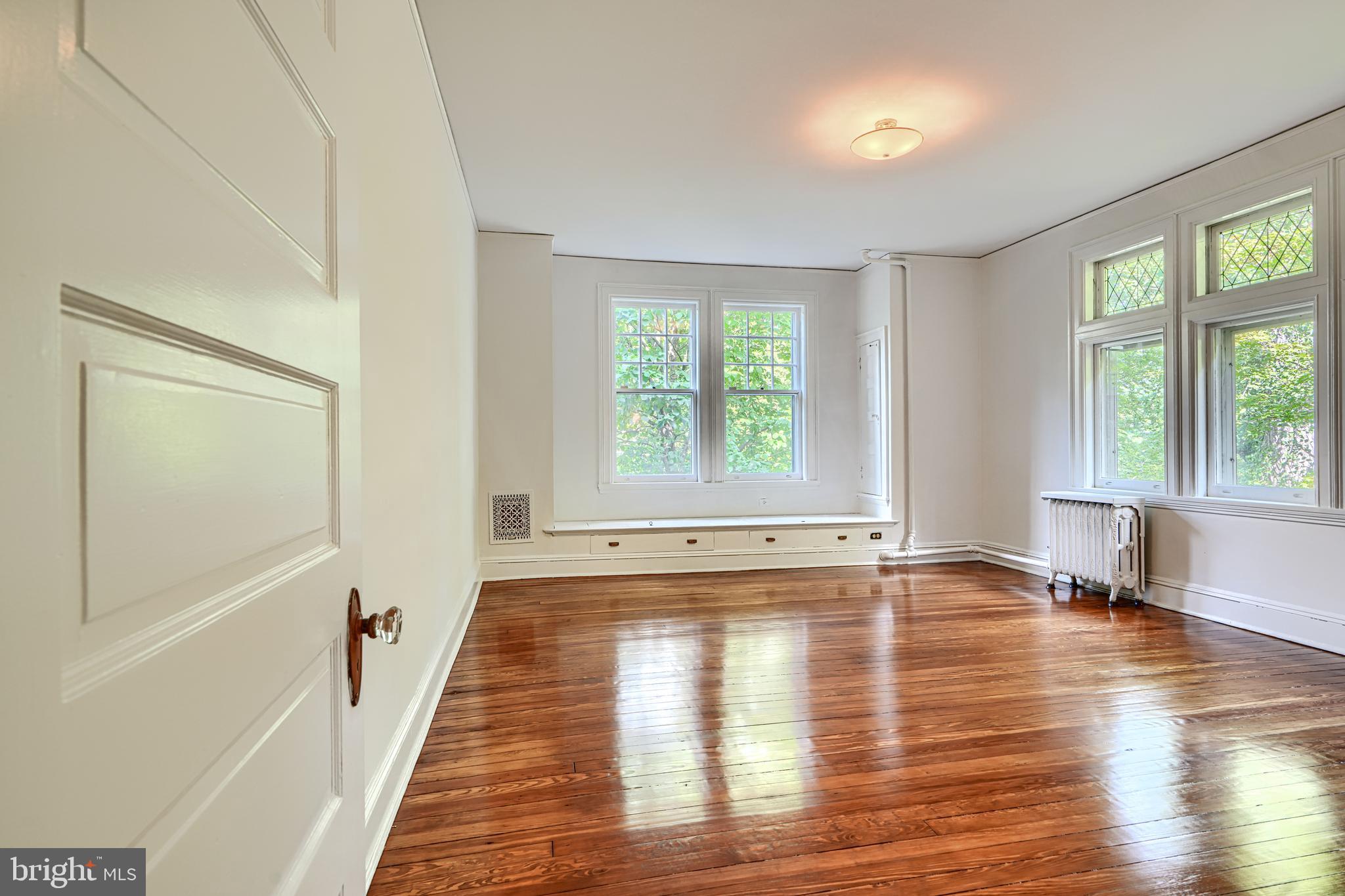 210 Ridgewood Road Baltimore, MD 21210 - Photo 34 of 84 a view of empty room with wooden floor and fan