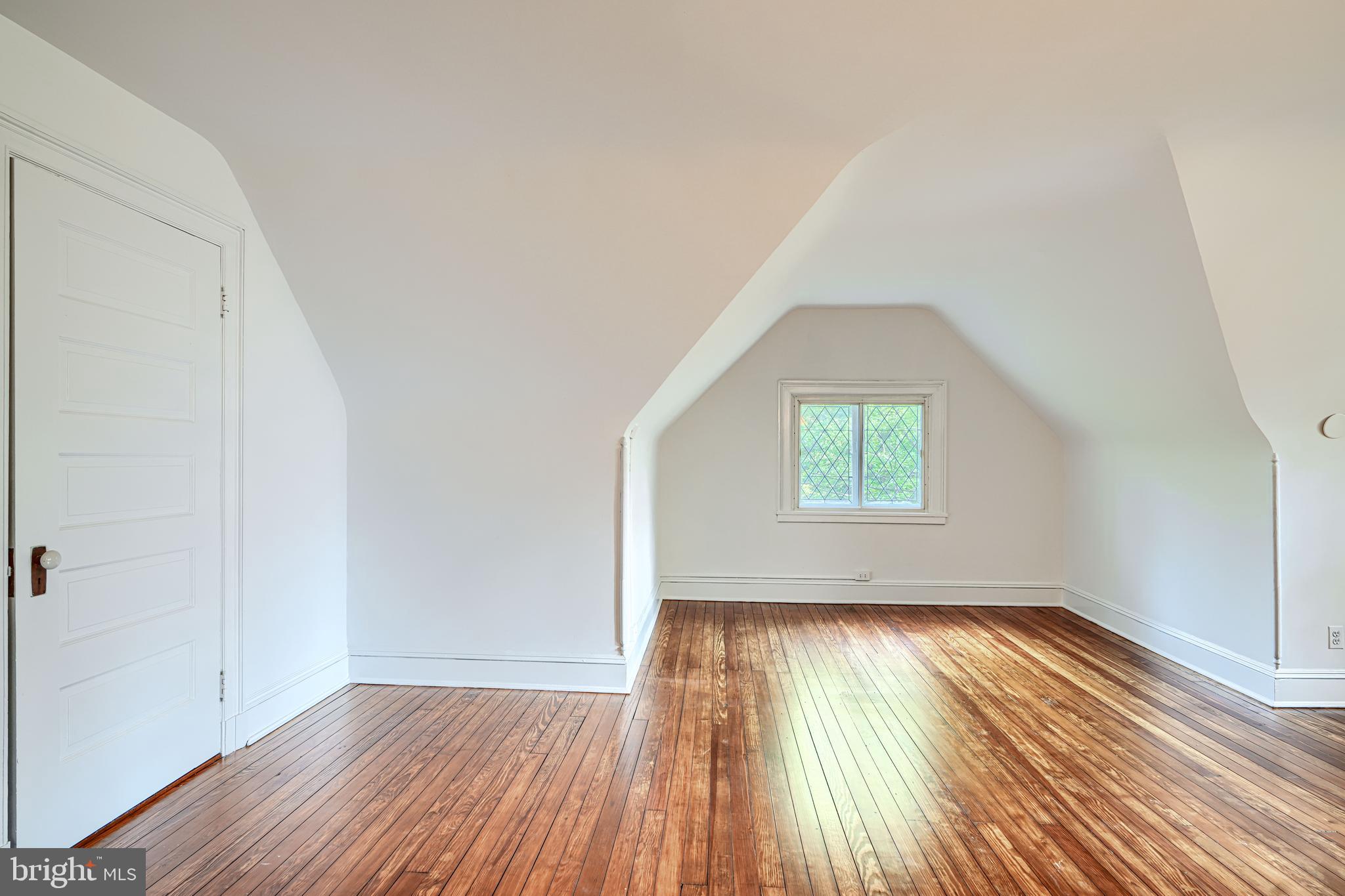210 Ridgewood Road Baltimore, MD 21210 - Photo 44 of 84 an empty room with wooden floor and windows