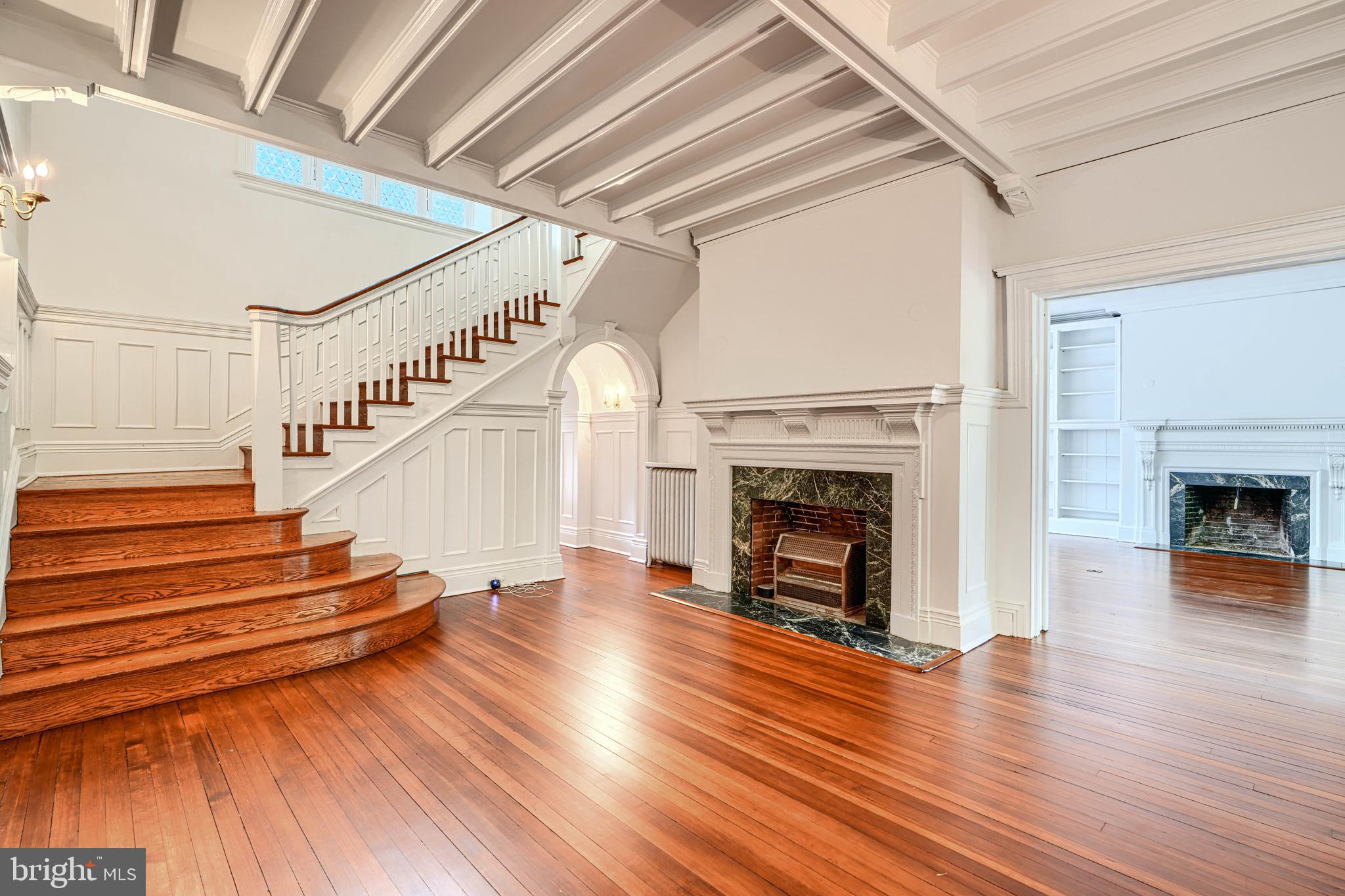 210 Ridgewood Road Baltimore, MD 21210 - Photo 7 of 84 a view of a livingroom with wooden floor and a fireplace