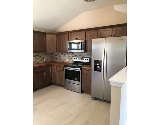 198 Treetop Avenue Springfield, MA 01118 - Photo 11 of 26 a kitchen with stainless steel appliances granite countertop a refrigerator and a stove