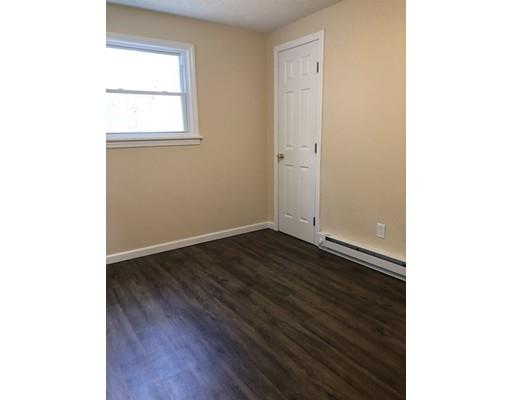 198 Treetop Avenue Springfield, MA 01118 - Photo 21 of 26 a view of an empty room with wooden floor and a window