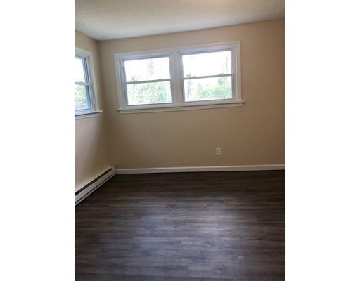 198 Treetop Avenue Springfield, MA 01118 - Photo 22 of 26 a view of an empty room with wooden floor and a window