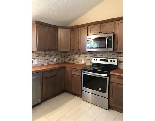 198 Treetop Avenue Springfield, MA 01118 - Photo 10 of 26 a kitchen with stainless steel appliances granite countertop a stove microwave and sink