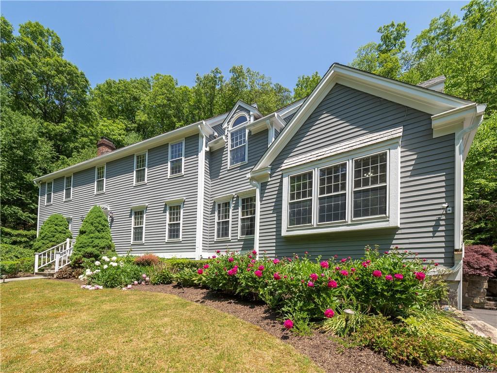 586 Redding Road Redding, CT 06896 - Photo 1 of 1 a house with a flower garden in front of it
