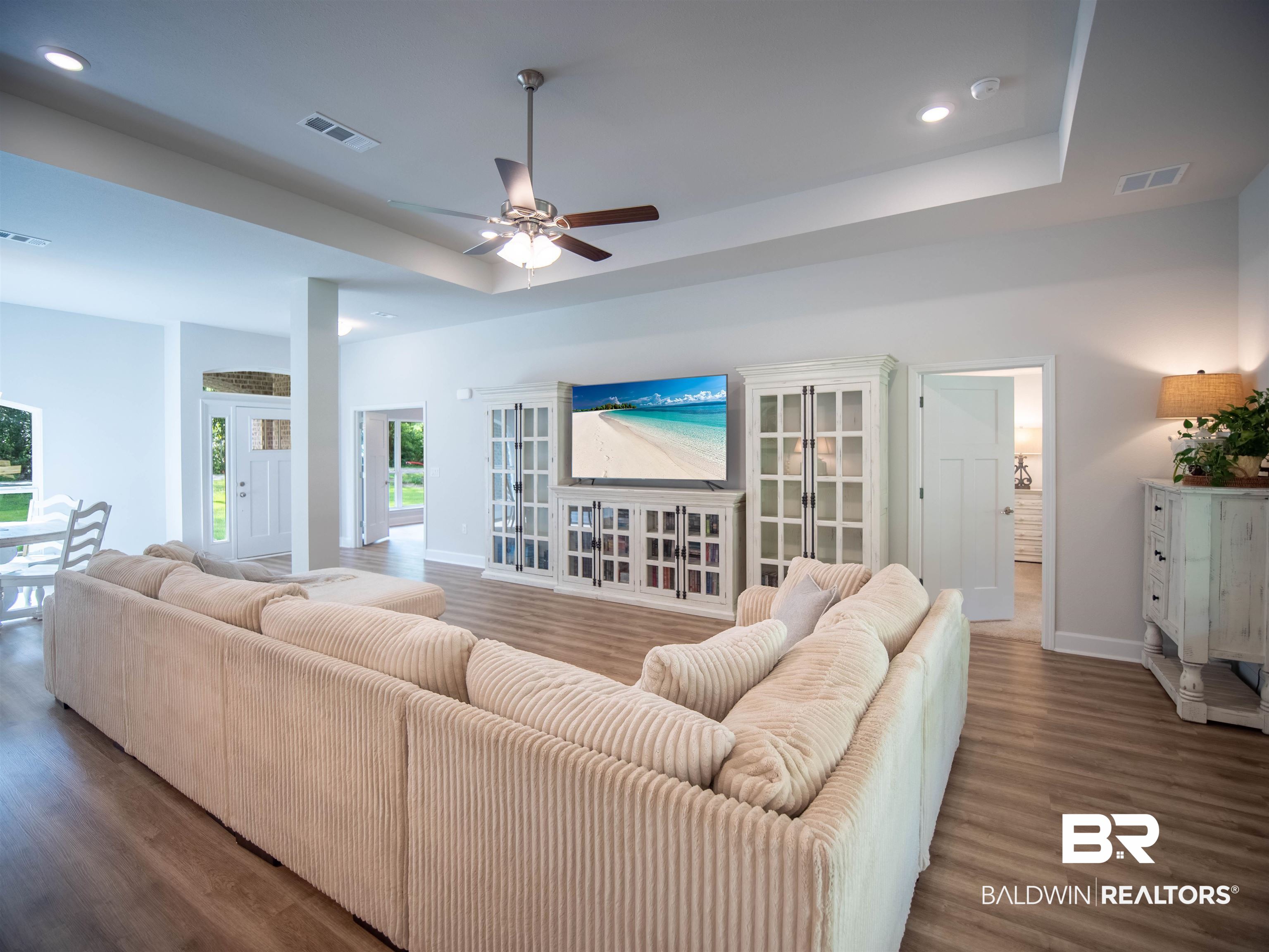 12646 Michigan Avenue Elberta, AL 36530 - Photo 7 of 47 Living area featuring a raised ceiling, wood finished floors, recessed lighting, and ceiling fan
