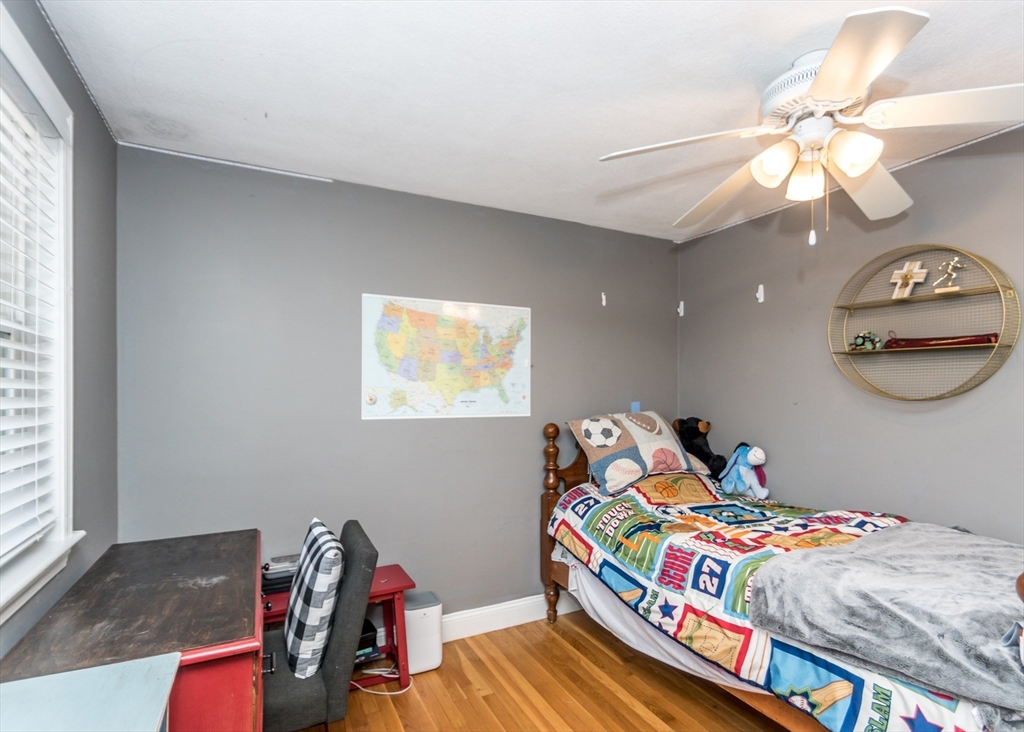27 Sherman Street Needham, MA 02494 - Photo 18 of 32 a bedroom with a bed and a chandelier
