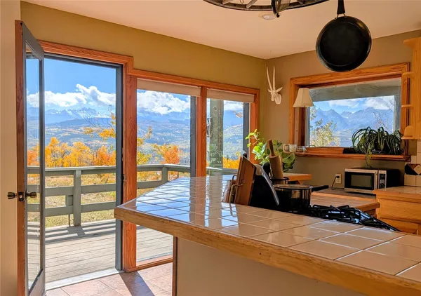 a view of a livingroom with workspace and a window
