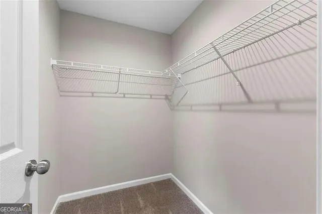 a bathroom with a granite countertop toilet sink and mirror