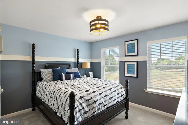 a bedroom with a bed and painting on the wall