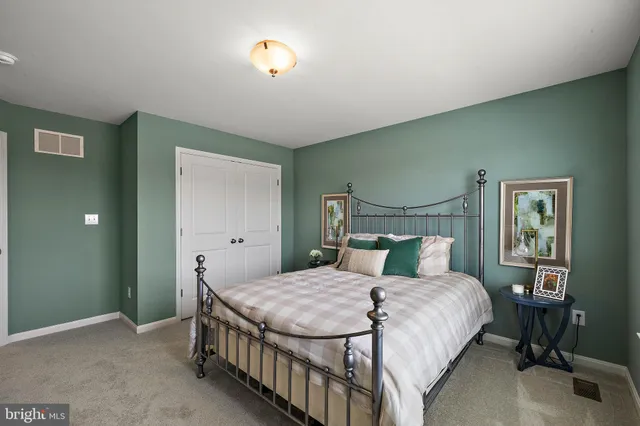 a front view of a house with a yard and green space