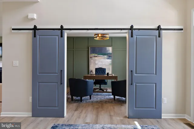 a view of living room with furniture and wooden floor