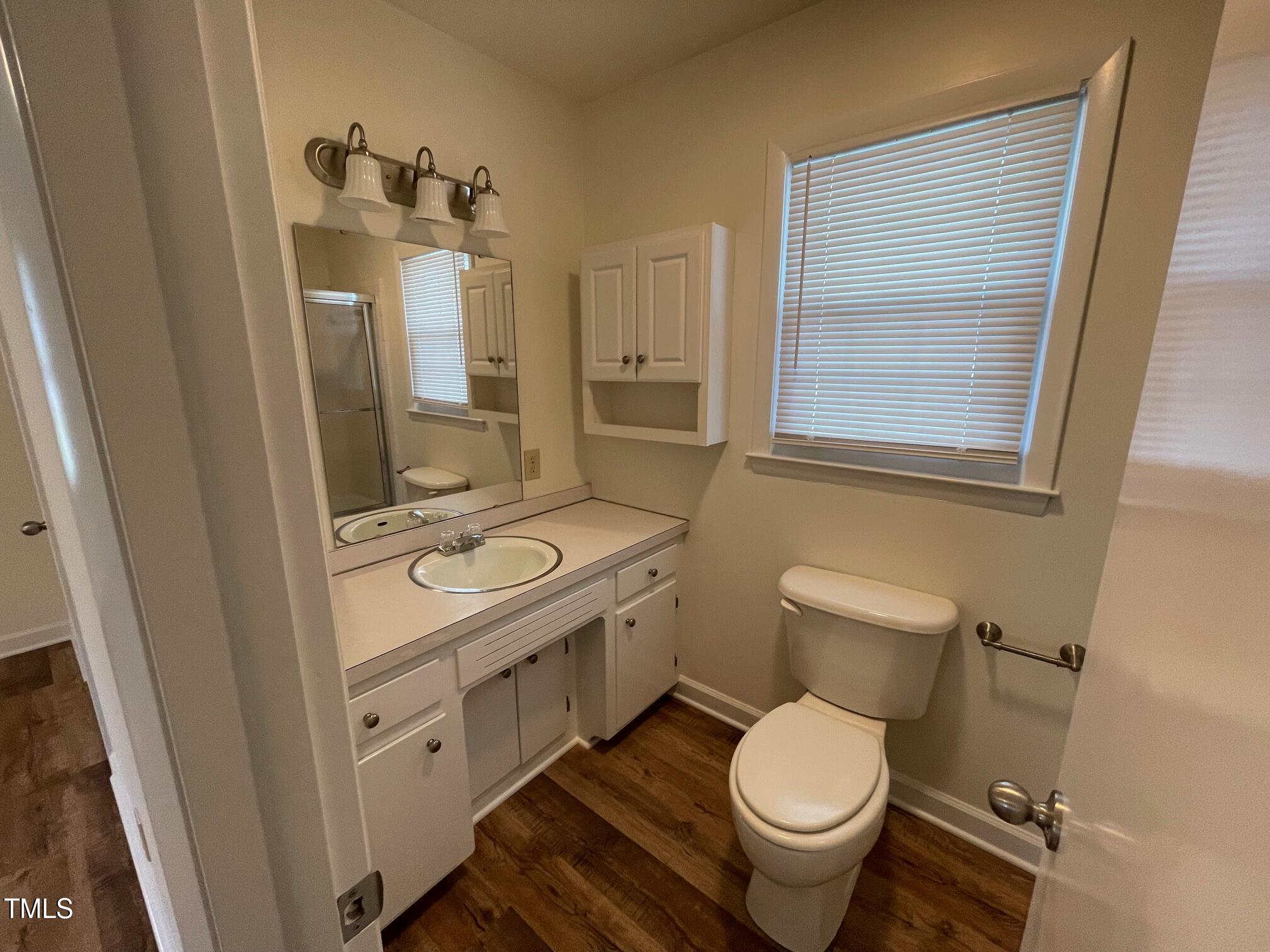 140 South Dunn Street Angier, NC 27501 - Photo 13 of 27 a bathroom with a granite countertop toilet sink and mirror