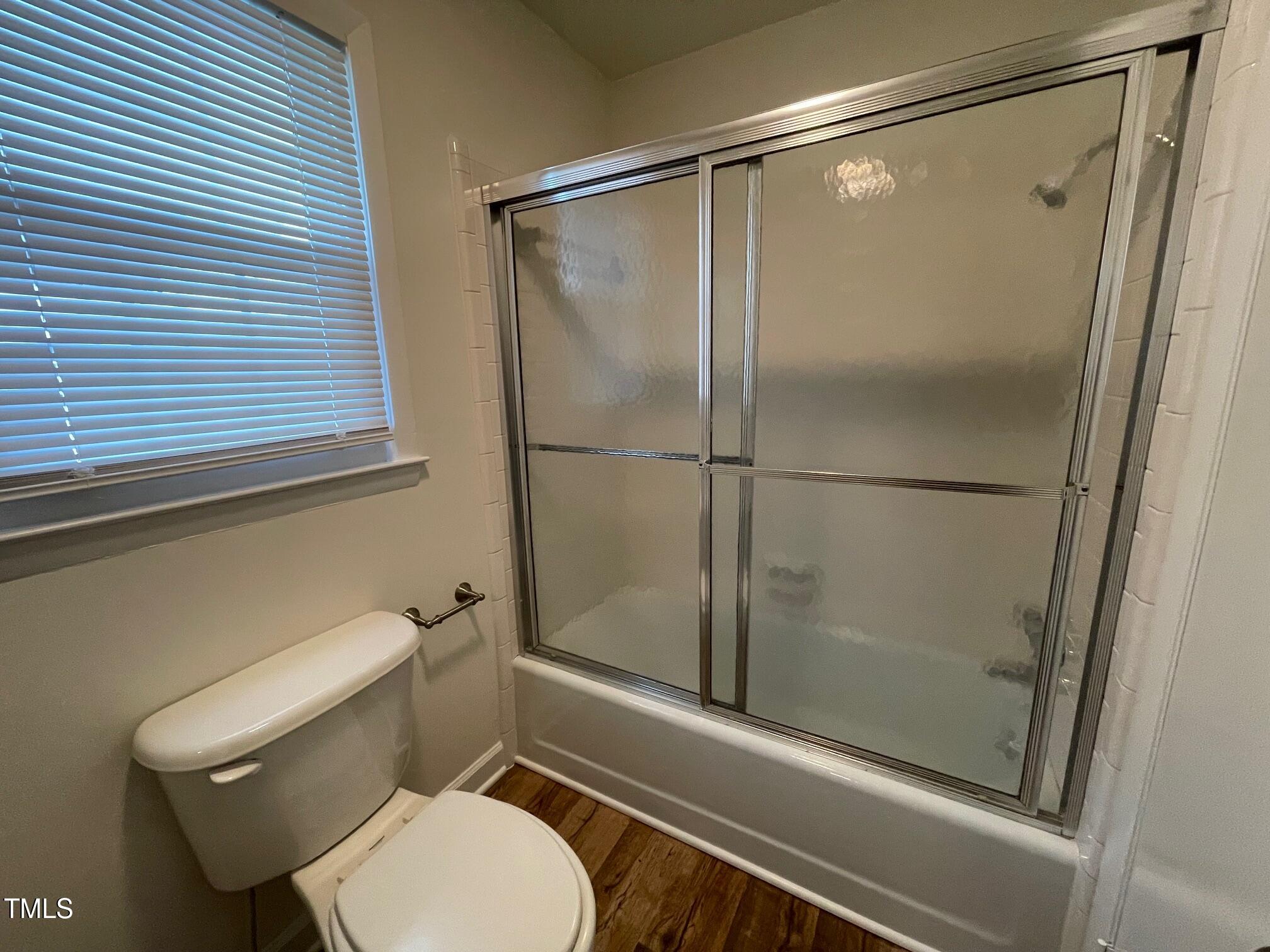 140 South Dunn Street Angier, NC 27501 - Photo 14 of 27 a bathroom with a toilet and a shower