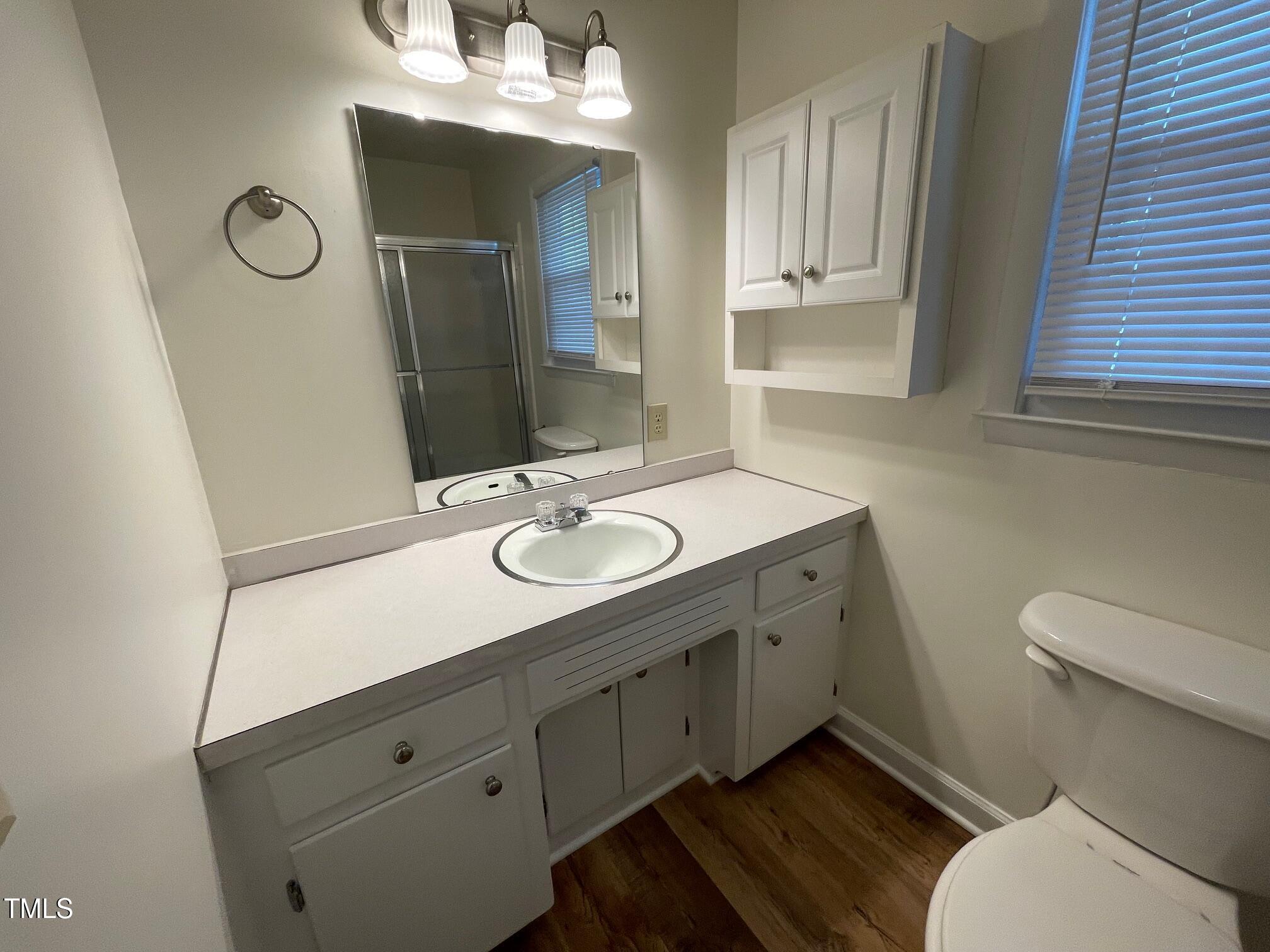 140 South Dunn Street Angier, NC 27501 - Photo 15 of 27 a bathroom with a sink toilet and mirror