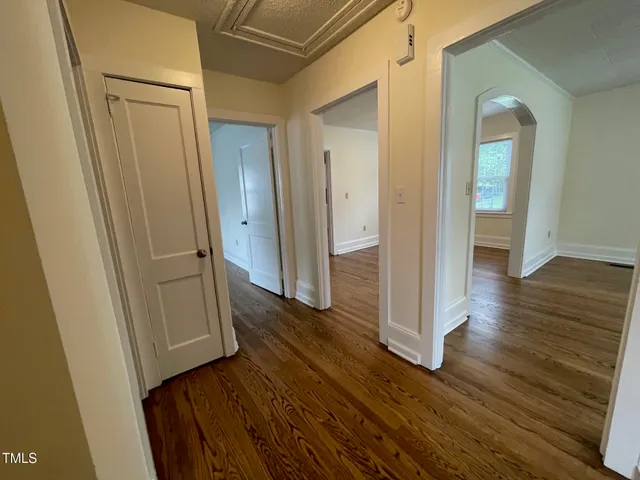 a view of a hallway with wooden floor