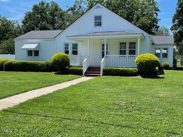 140 South Dunn Street Angier, NC 27501 - Photo 2 of 27 a view of house with a yard and potted plants
