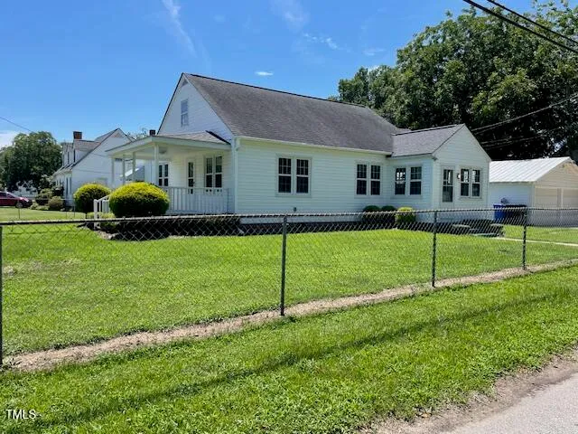 a house view with a sitting space and garden