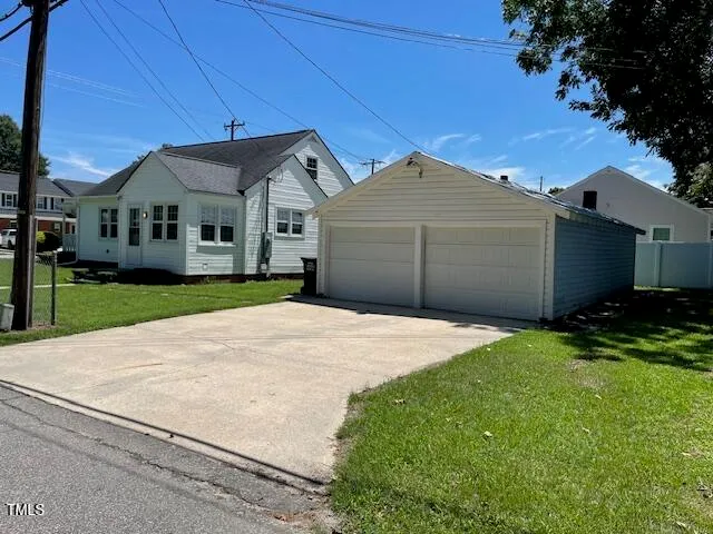 a front view of a house with yard and garage