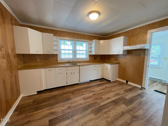 a view of a kitchen with sink cabinets and wooden floor