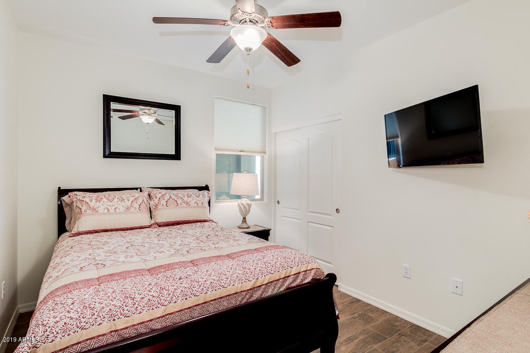7726 East Baseline Road, Unit 143 Mesa, AZ 85209 - Photo 17 of 27 a bedroom with a bed and a flat screen tv