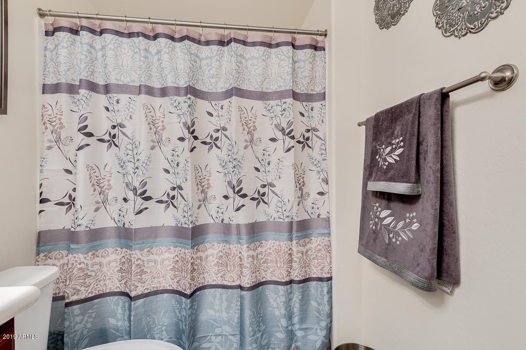 7726 East Baseline Road, Unit 143 Mesa, AZ 85209 - Photo 19 of 27 a bathroom with a bathtub and shower