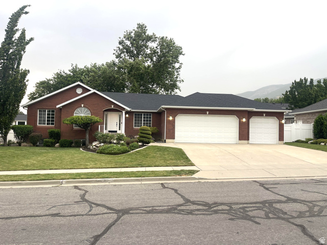 356 West Sunset Circle Centerville, UT 84014 - Photo 1 of 27 Brick exterior with a three-car garage, concrete driveway, and manicured lawn