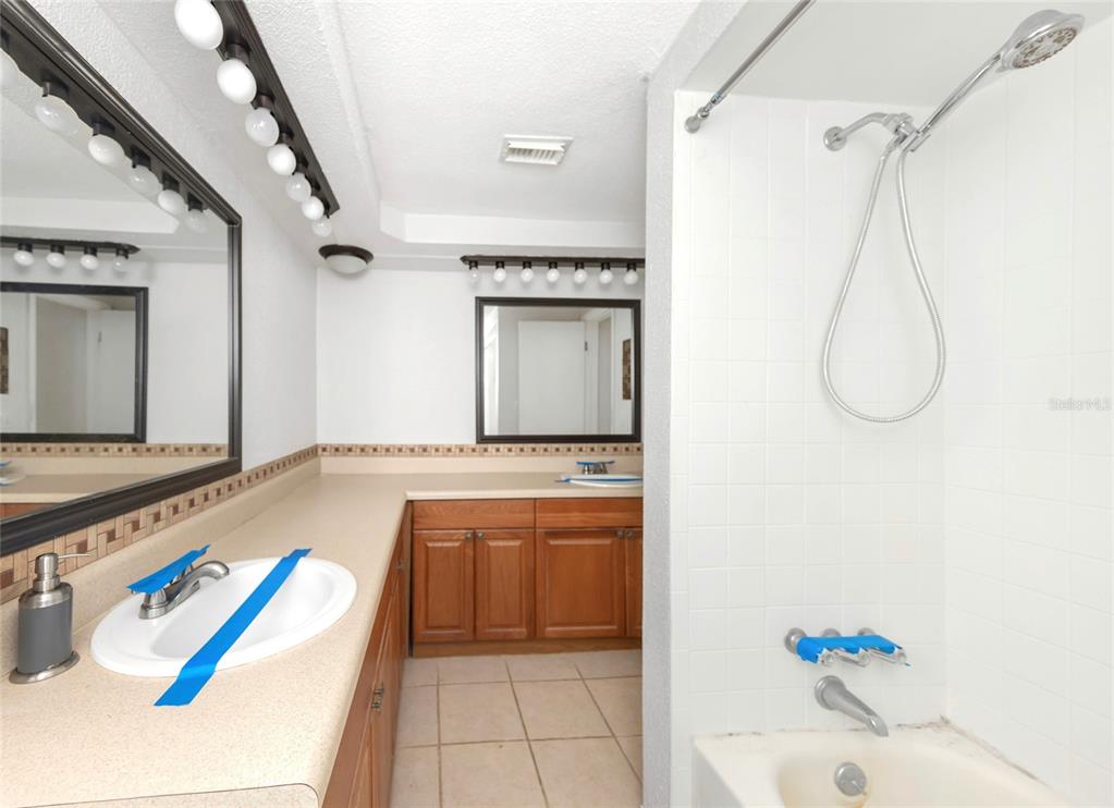 3105 Pinon Drive Holiday, FL 34691 - Photo 13 of 23 a bathroom with a tub sink and mirror