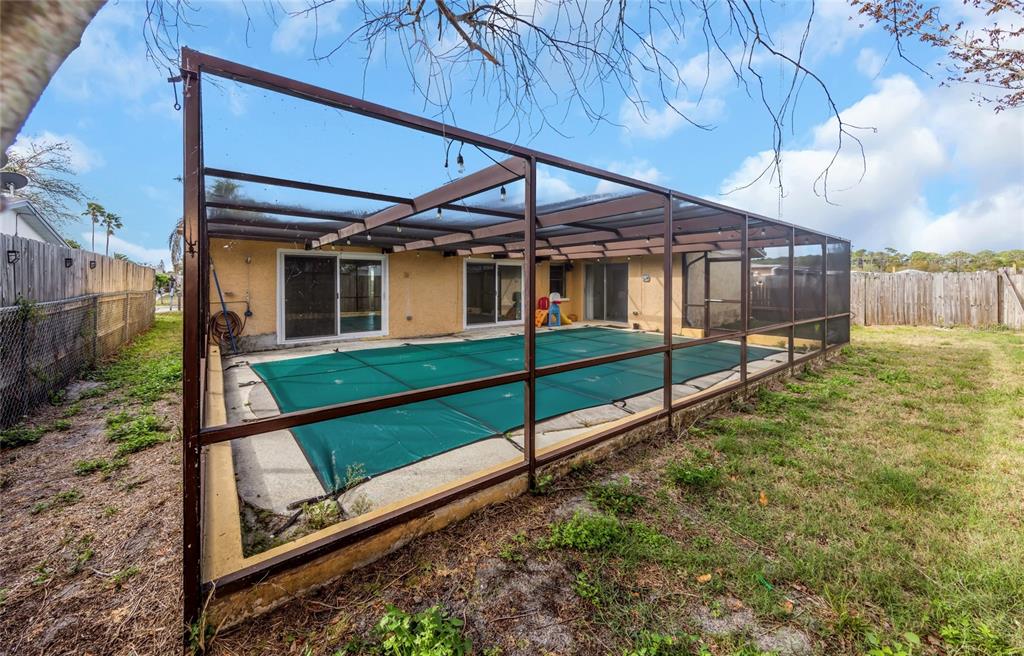 3105 Pinon Drive Holiday, FL 34691 - Photo 22 of 23 a view of a house with wooden fence