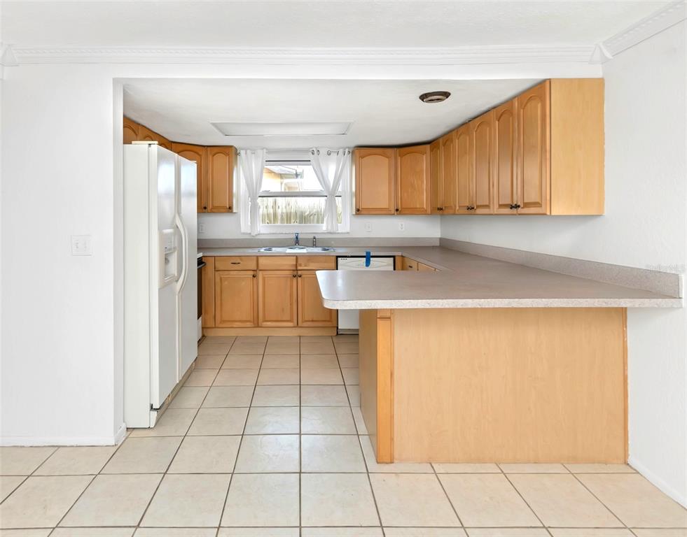 3105 Pinon Drive Holiday, FL 34691 - Photo 7 of 23 a kitchen with stainless steel appliances a refrigerator sink and cabinets