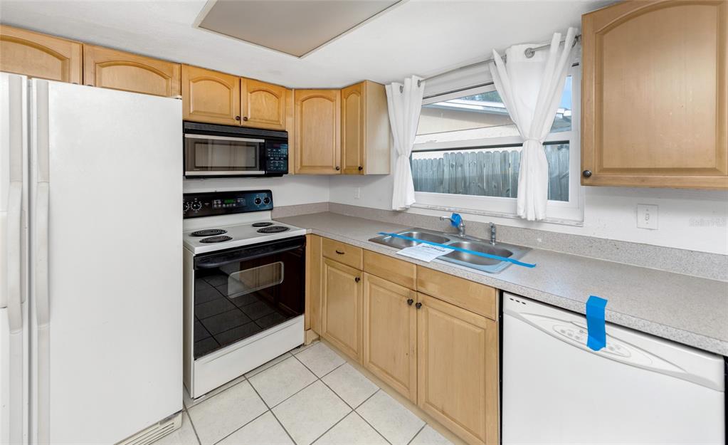 3105 Pinon Drive Holiday, FL 34691 - Photo 8 of 23 a kitchen with stainless steel appliances a stove a sink and a refrigerator