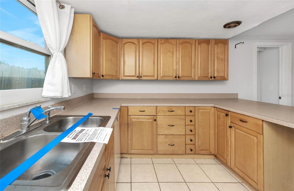 3105 Pinon Drive Holiday, FL 34691 - Photo 9 of 23 a kitchen with granite countertop a refrigerator and a stove top oven