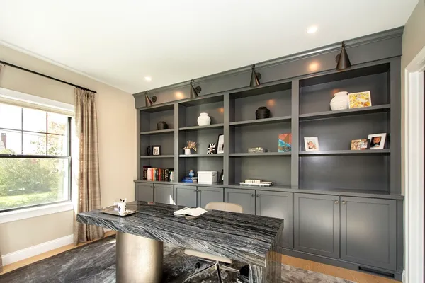 a kitchen with granite countertop stainless steel appliances a table and a large window